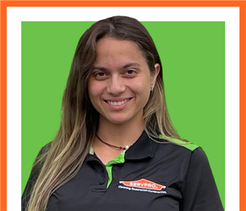 SERVPRO employee, cut out and set against a green backdrop